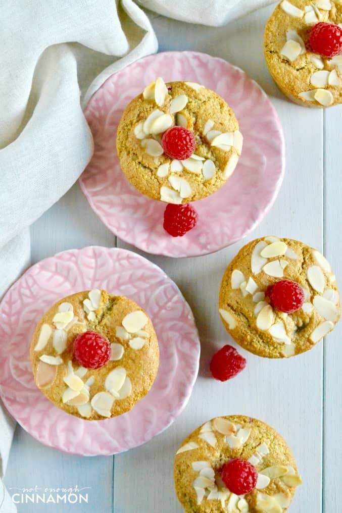 overhead shot of healthy raspberry almond muffins on small pink plates