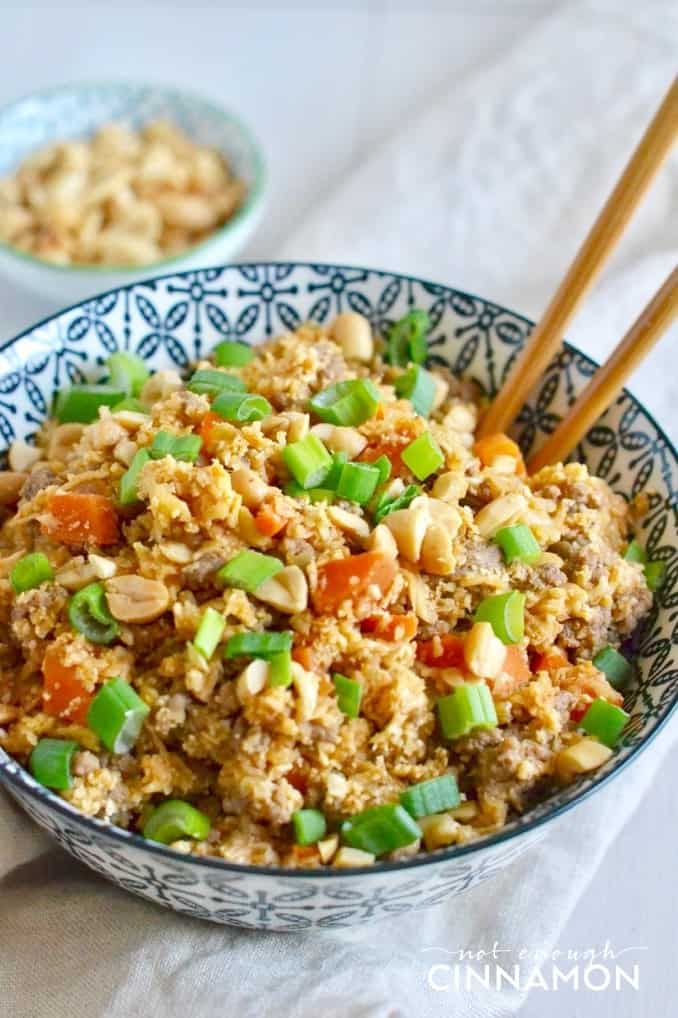 a bowl of low carb Asian cauliflower fried rice with chopsticks 