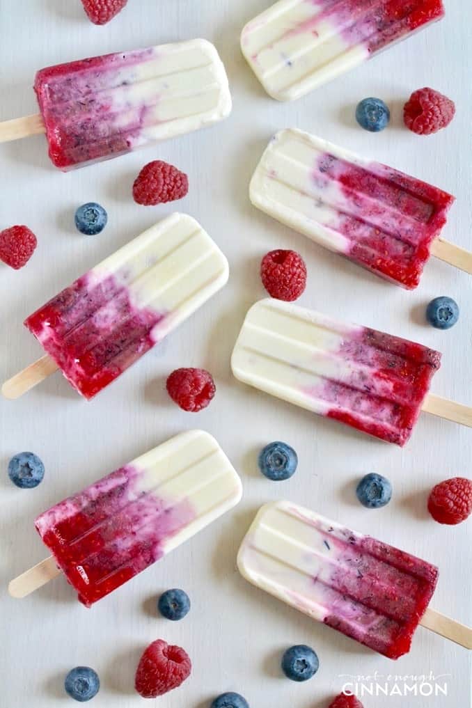 refined sugar-free Mixed Berry & Greek Yogurt Popsicles on a white tabletop