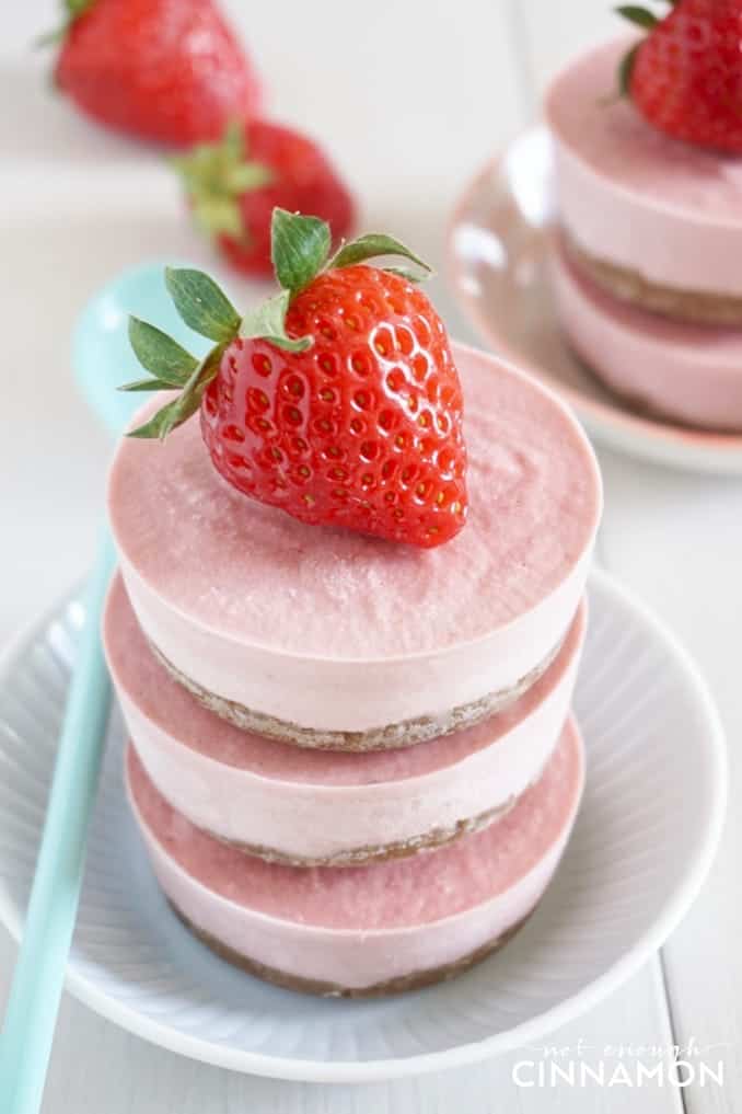 three stacked bite-sized Vegan Strawberry Cheesecake on a white plate