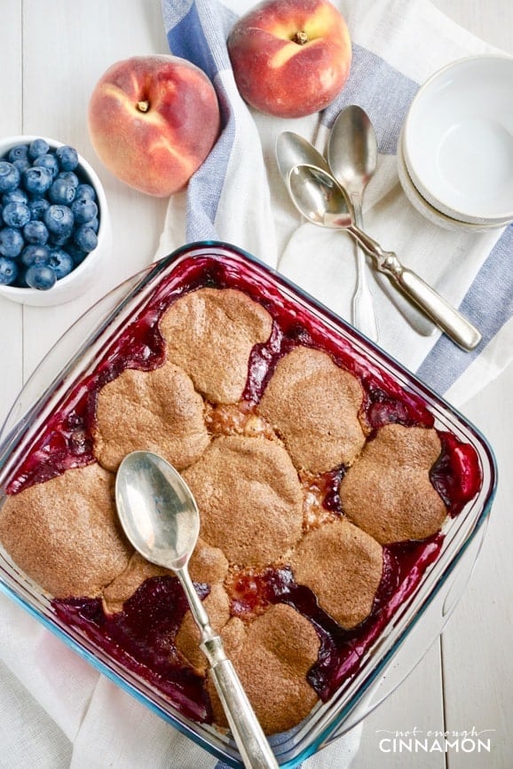 overhead shot of peach blueberry cobbler in a square pyrex baking dish