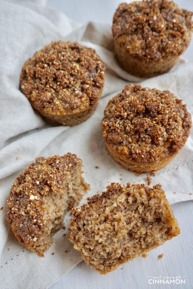 overhead shot of Gluten Free Apple Snickerdoodle Muffins with crumb topping on a white tablecloth