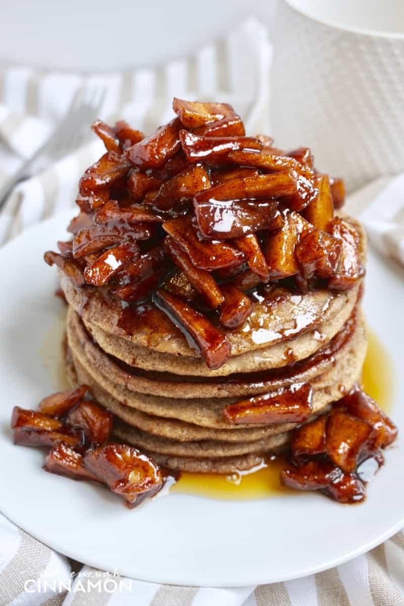 a stack of gluten-free apple cinnamon pancakes topped with sauteed cinnamon apples