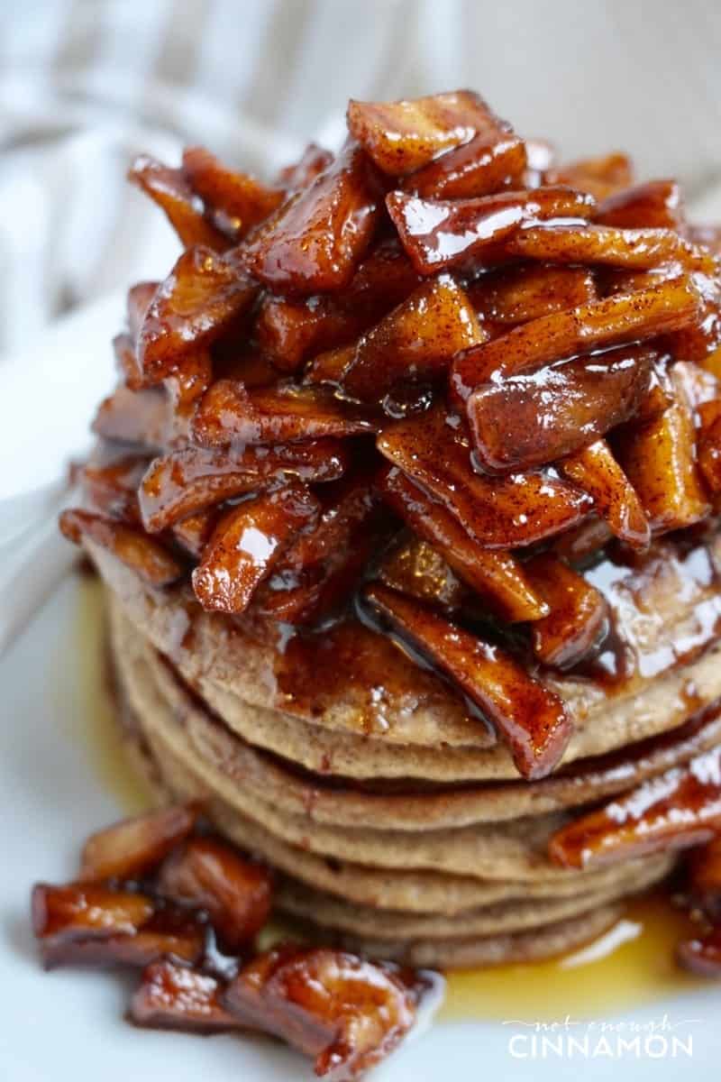close-up of a stack of gluten-free apple cinnamon pancakes topped with sauteed apples