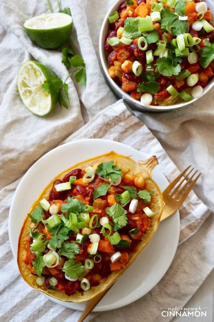 overhead shot of Spaghetti squash stuffed with vegan chili on a white plate