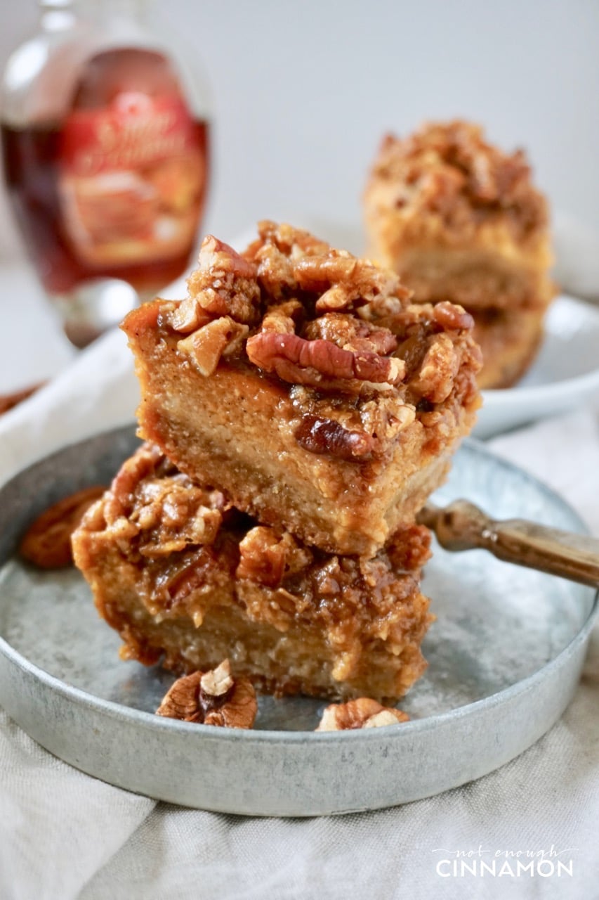 side view of Healthy Pumpkin Pecan Bars stacked on a small metal plate