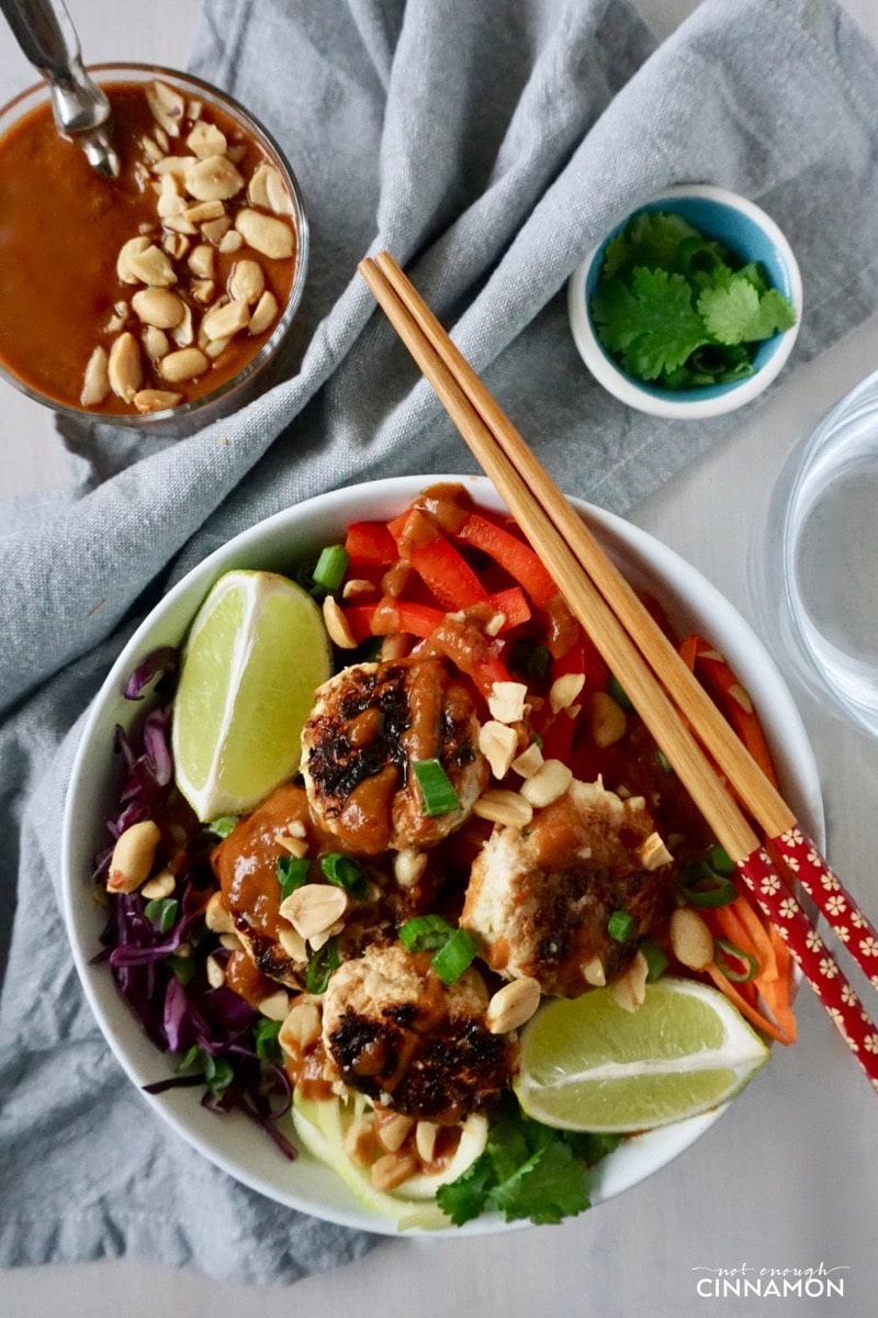 overhead shot of a Thai-inspired veggie bowl with spiralized veggies and mini Thai chicken patties 