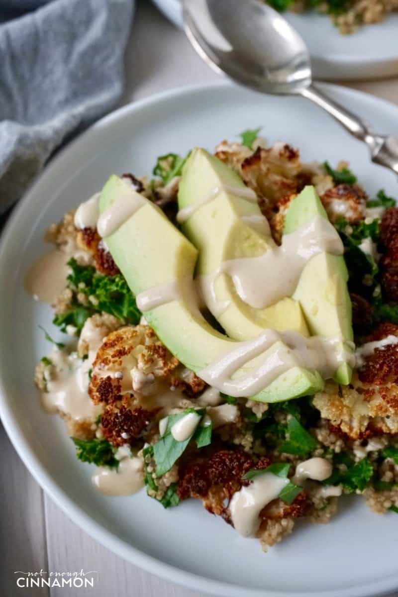 overhead shot of quinoa detox plate with oven-roasted cauliflower, kale and avocado slices