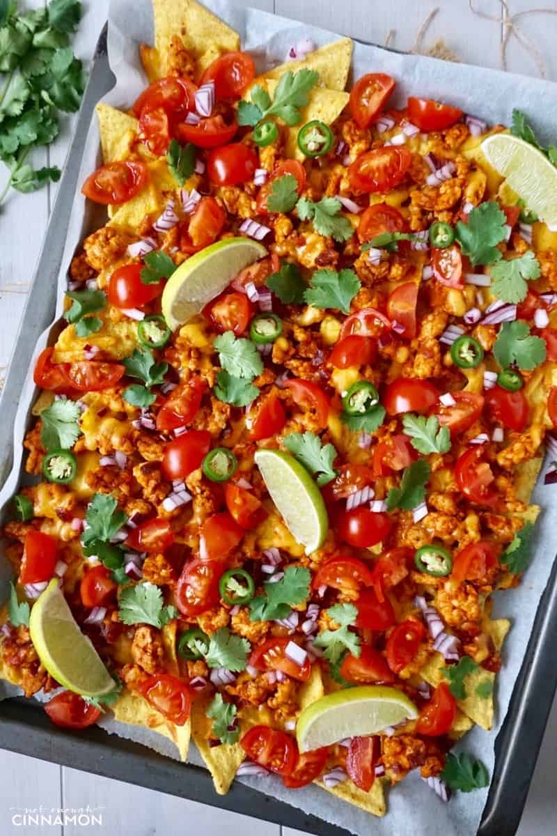 sheet pan nachos made with ground turkey, cilantro and tomatoes