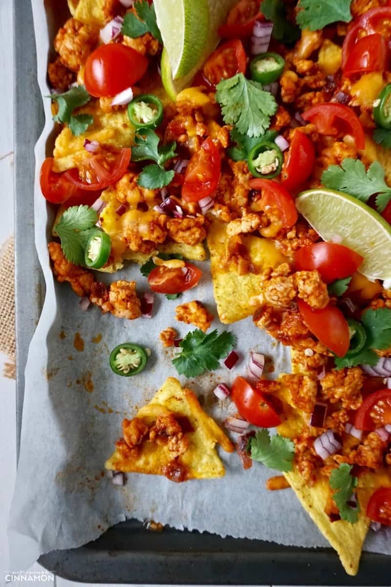 overhead shot of easy sheet pan nachos made with ground turkey, cilantro, jalapenos and baked tortillas