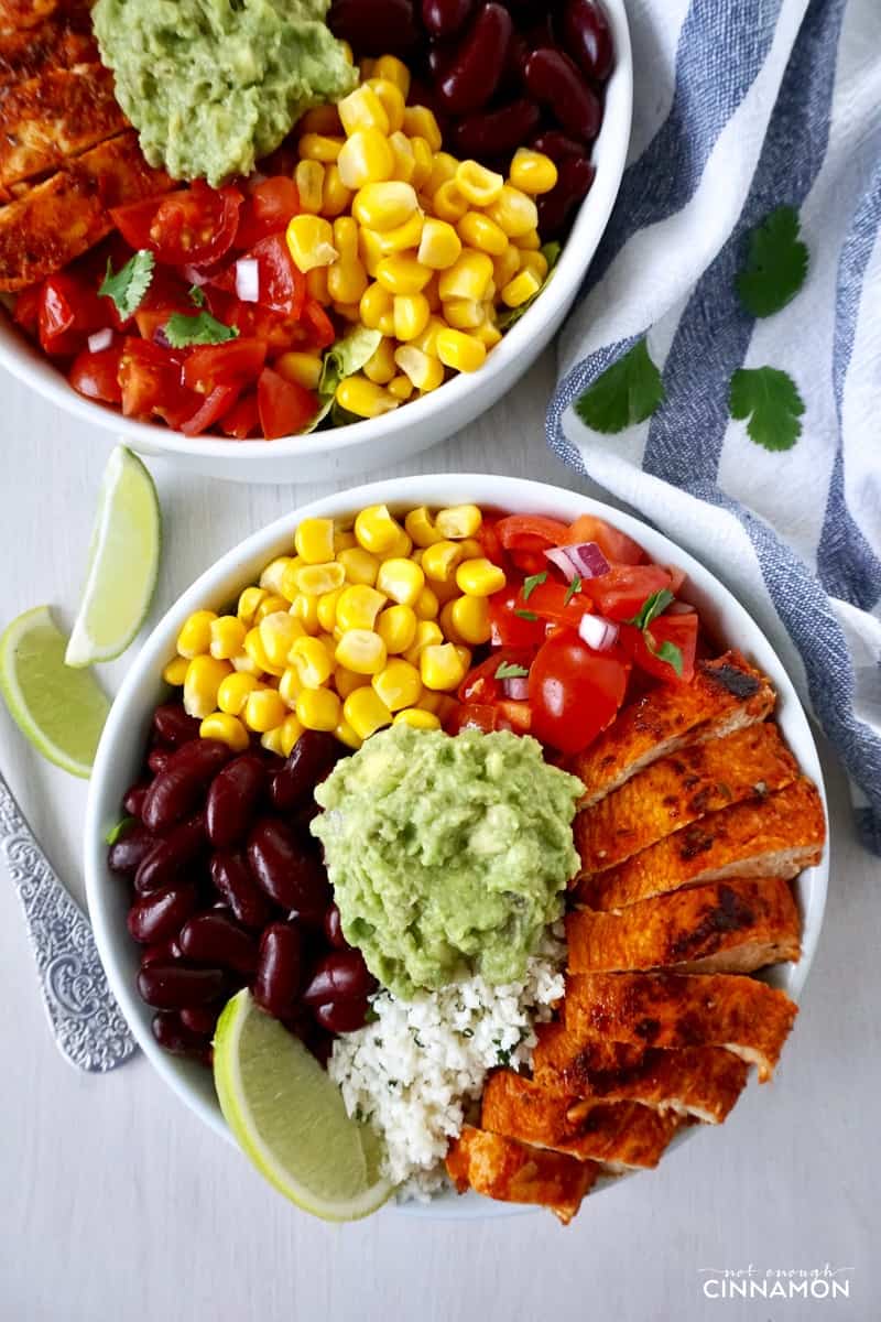 overhead shot of two Chipotle's Chicken Burrito Bowls with Cilantro Lime Cauliflower Rice and guacamole