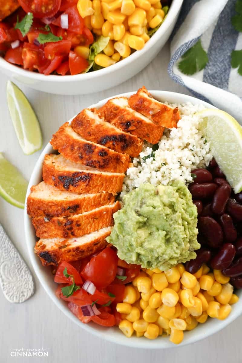 overhead shot of Chipotle's Chicken Burrito Bowl with Cilantro Lime Cauliflower Rice, guacamole, black beans and corn