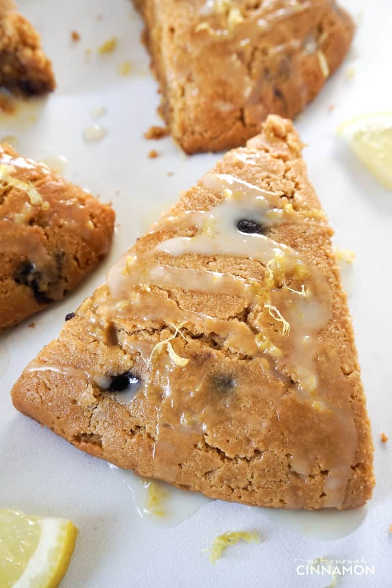 close-up on lemon blueberry scones made with almond flour drizzled with lemon glaze