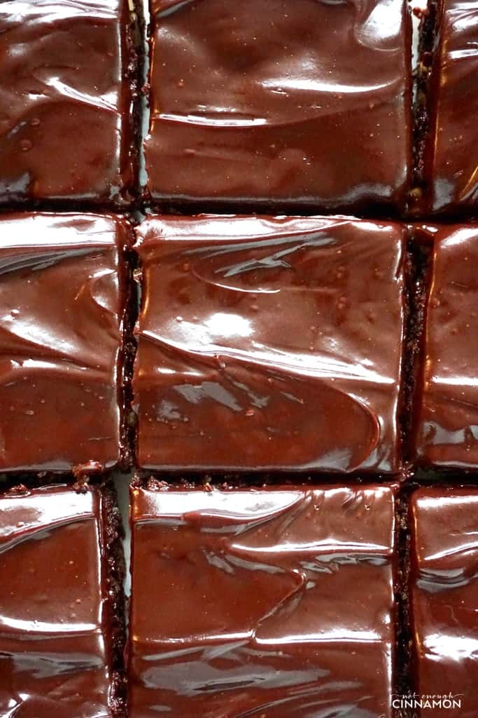 overhead shot of paleo brownies with shiny coconut cream chocolate glaze freshly cut into squares