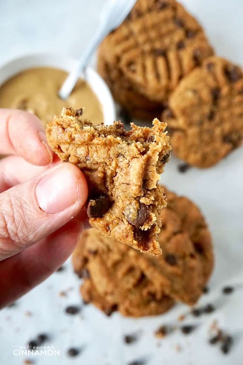 a hand holding a piece of Peanut Butter and Chocolate Cookie