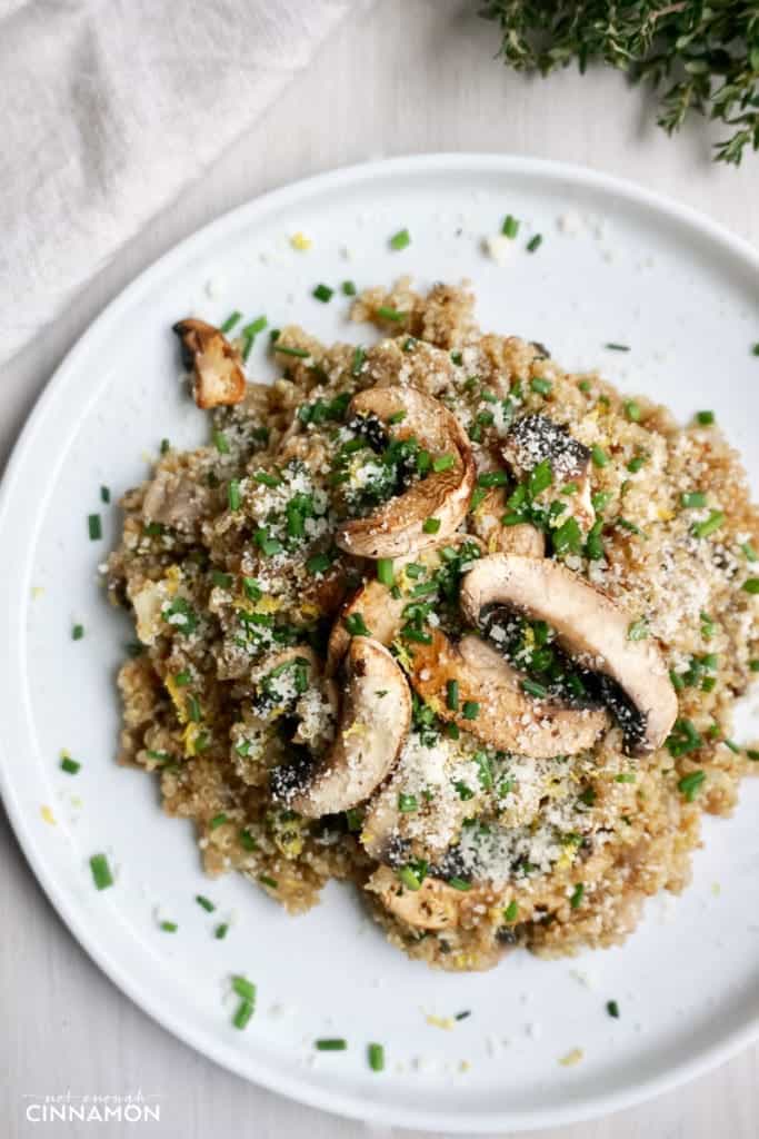 overhead shot of a plate of Mushroom Quinoa Risotto sprinkled with chives