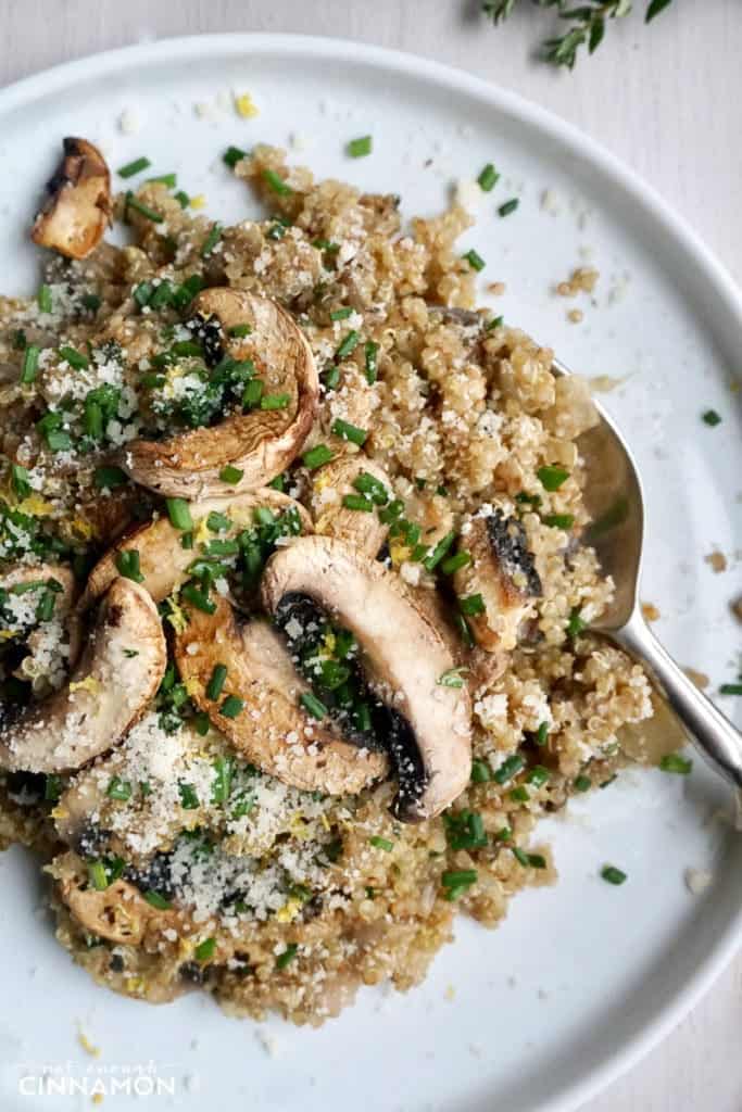 close-up of a plate of Mushroom Quinoa Risotto with a spoon on the side