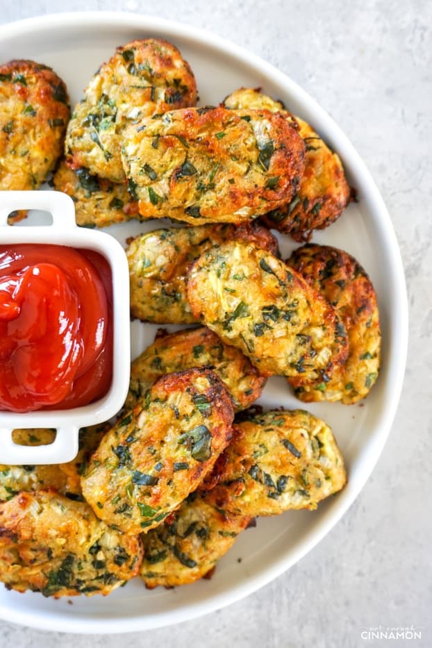 Overhead shot of a plate of zucchini tots with ketchup