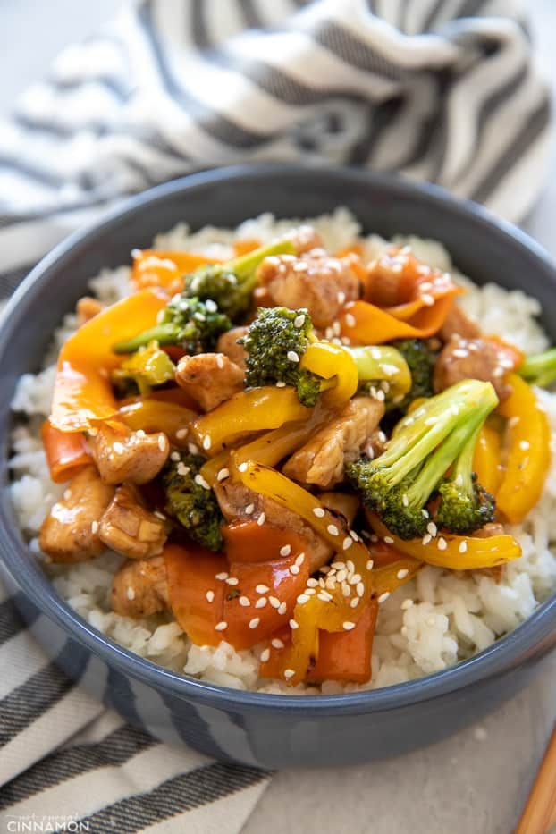 close-up of a bowl of Chinese 5-Spice Chicken served over rice and sprinkled with sesame seeds