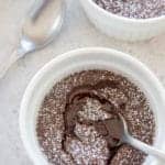 overhead shot of a single serving molten chocolate lava cake in a small ramekin with a silver spoon sticking in