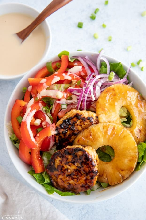 overhead shot of a healthy Hawaiian Chicken Burger Bowl drizzled with Whole30 teriyaki sauce