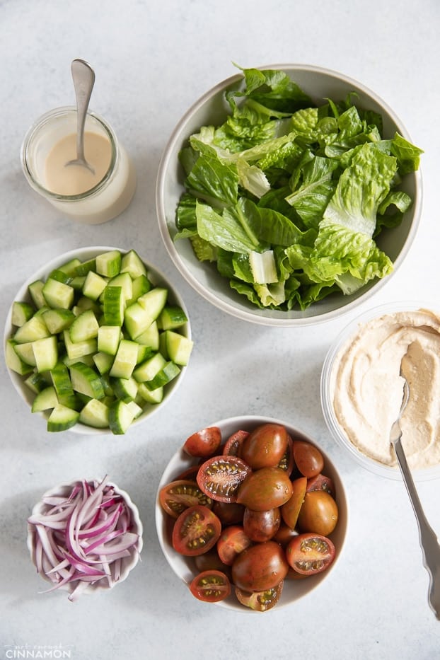 overhead shot of different toppings and sauces needed for making chicken shawarma bowls