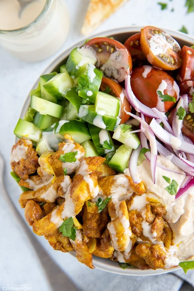 close-up overhead shot of a healthy chicken shawarma bowl with tahini sauce