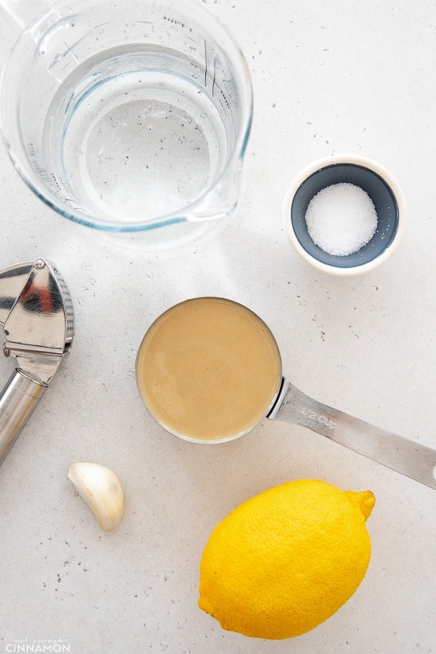 overhead shot of ingredients needed for making vegan tahini sauce for buddha bowls