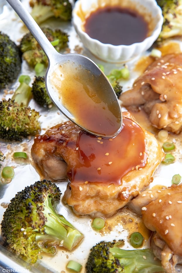 sticky Whole30 teriyaki glaze being spooned over an oven-baked chicken thigh