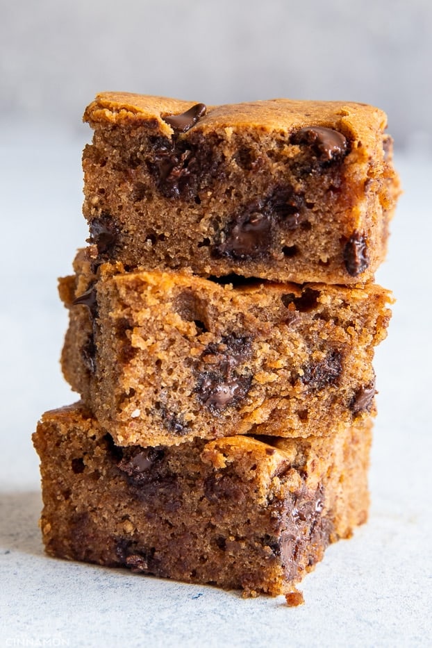 three stacked paleo almond butter blondies with melty dark chocolate chips 