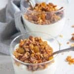carrot cake granola served sprinkled on top of healthy Greek Yogurt