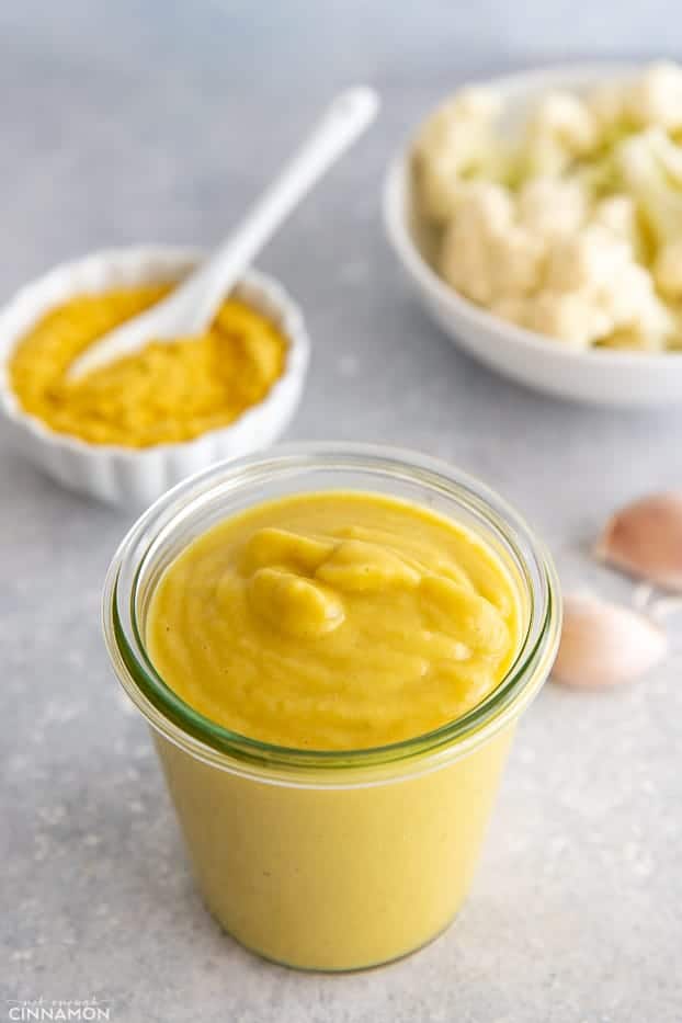 overhead shot of a jar of vegan cauliflower Alfredo sauce made with nutritional yeast 