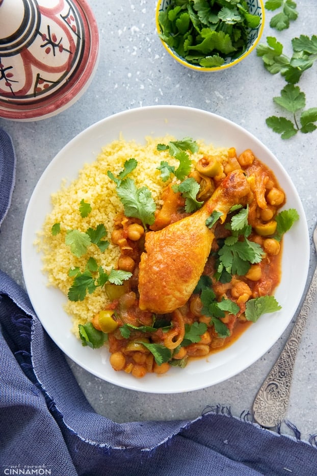 overhead shot of Moroccan chicken tagine stew served with couscous and fresh cilantro