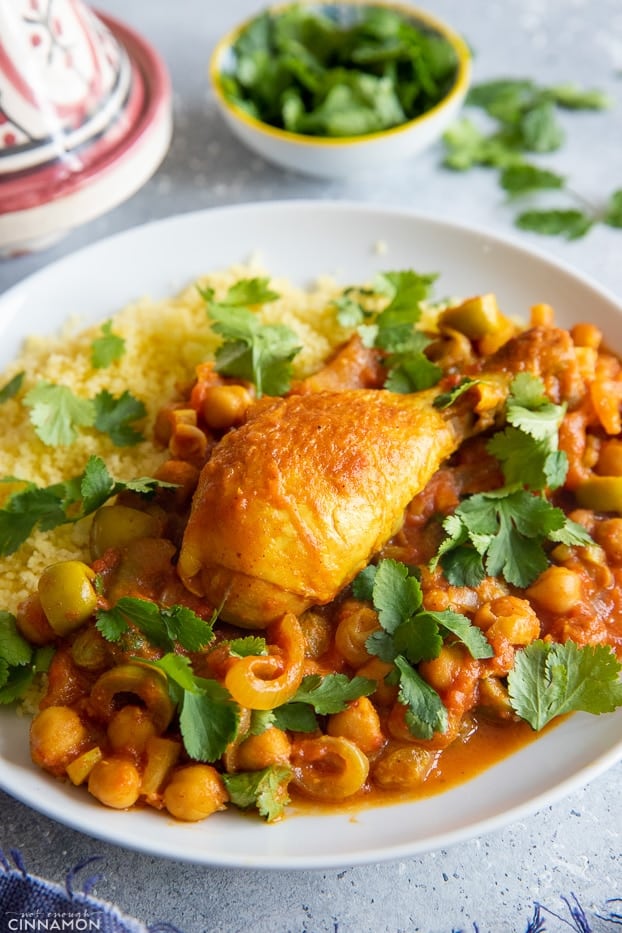 side view of a serving of healthy One Pot Moroccan chicken drumstick stew with a side of couscous