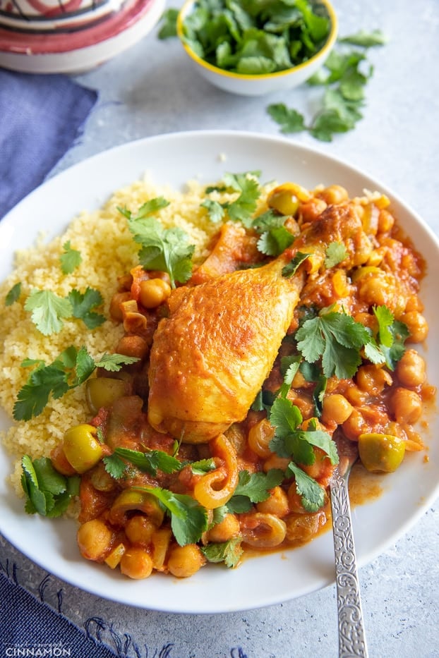 overhead shot of a serving of Moroccan chicken with chickpeas, olives and cilantro 