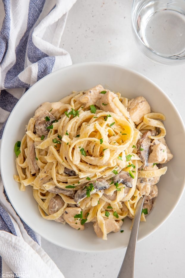 overhead shot of a plate of dairy-free fettuccine alfredo with chicken and mushrooms 