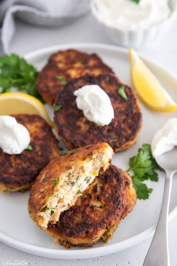 a gluten-free healthy paleo salmon cake being broken into two halves 