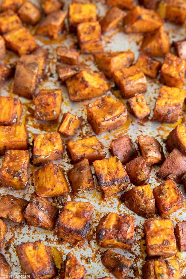 sweet potato cubes roasting on a sheet pan