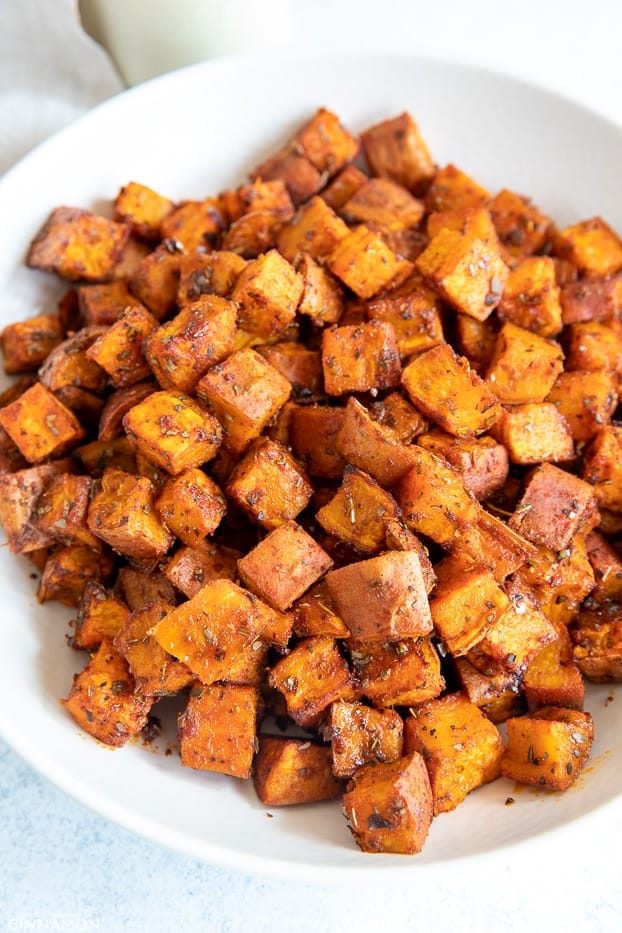 cubes of perfect oven roasted sweet potatoes on a white plate 