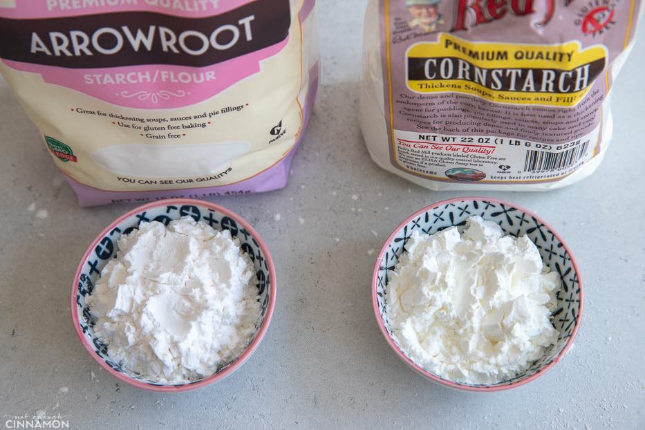 a small bowl of cornstarch next to a bowl with arrowroot flour 