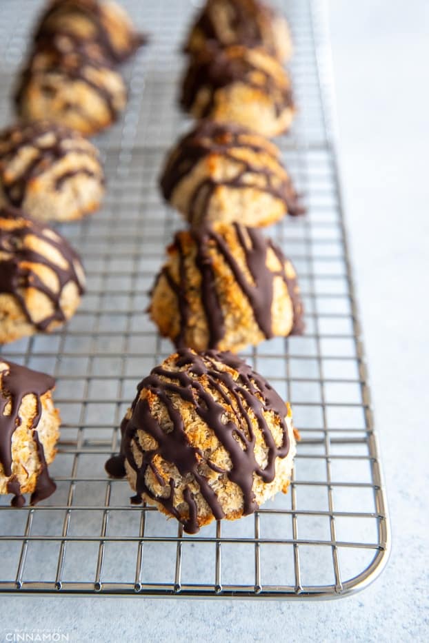 chocolate drizzled easy vegan coconut macaroons cooling on a wire rach