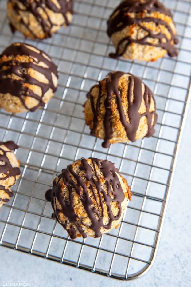 healthy chocolate drizzled paleo vegan coconut macaroons cooling on a wire rack