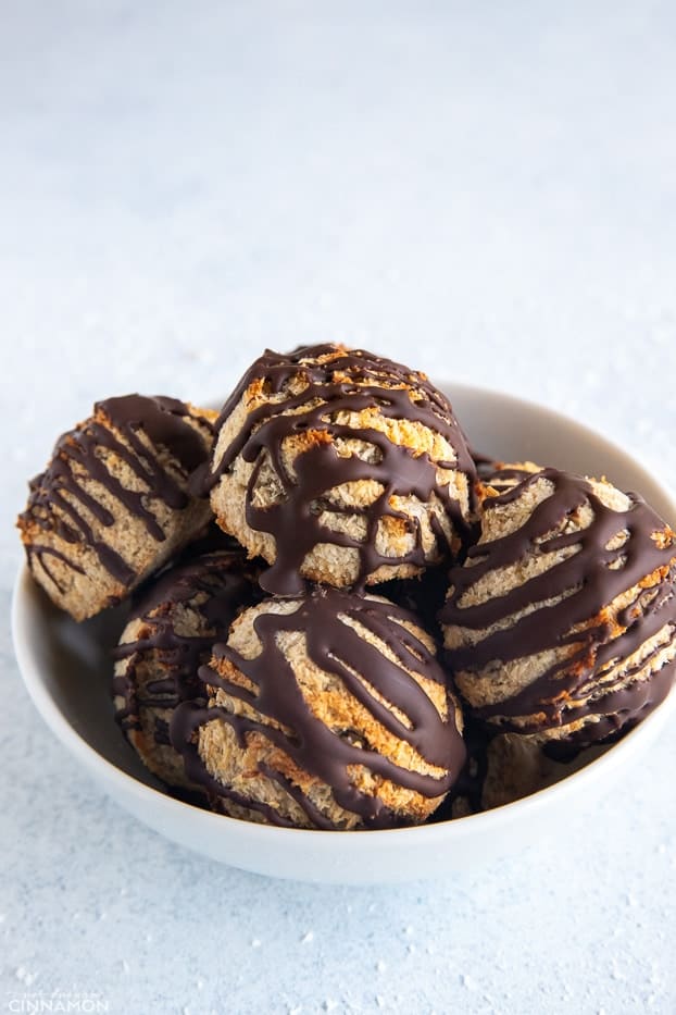 chocolate covered healthy 3-ingredient coconut macaroons in a small white bowl