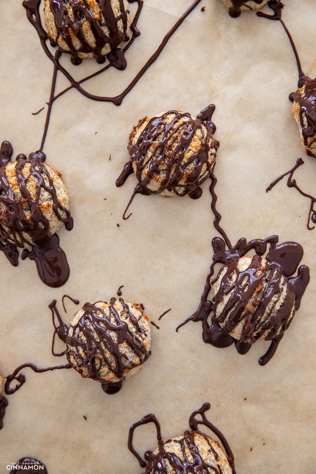 overhead shot of healthy 3 ingredient coconut banana macaroons drizzled with melted chocolate