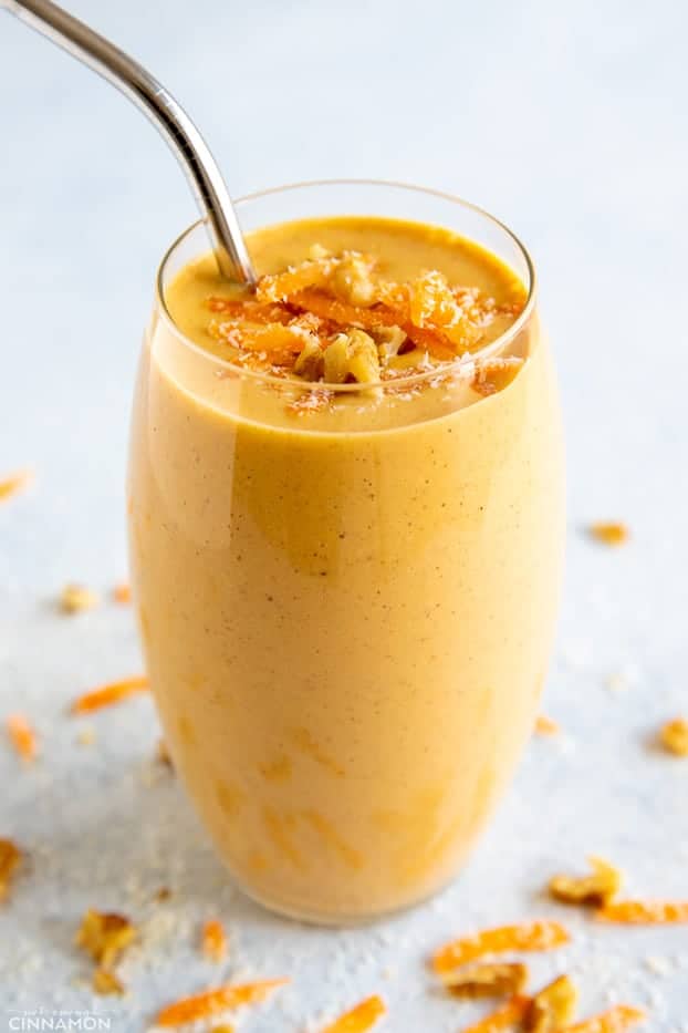 side view of a tall smoothie glass filled with carrot cake smoothie 