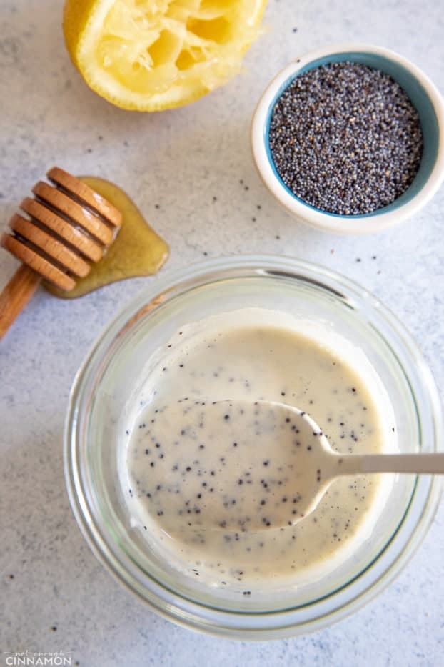 overhead shot of healthy dairy-free lemon poppy seed dressing in a small glass jar