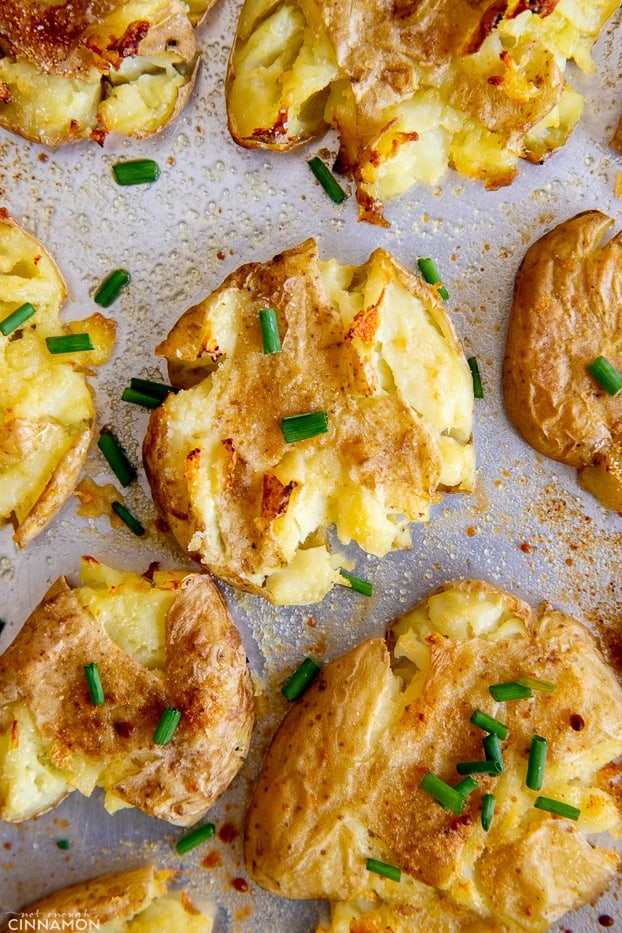 overhead shot of smashed potatoes on a baking sheet