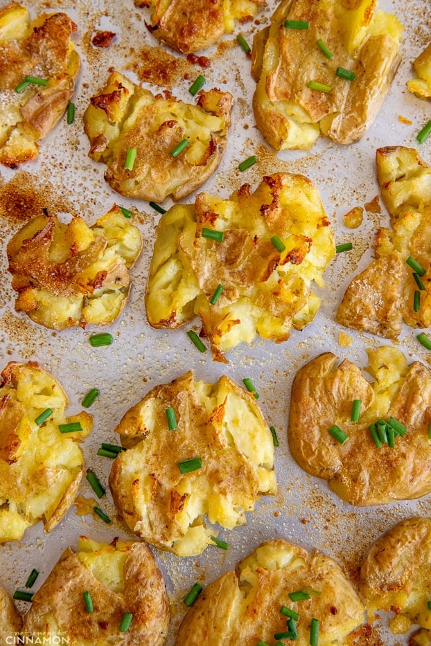 overhead shot of a baking sheet with smashed potatoes 