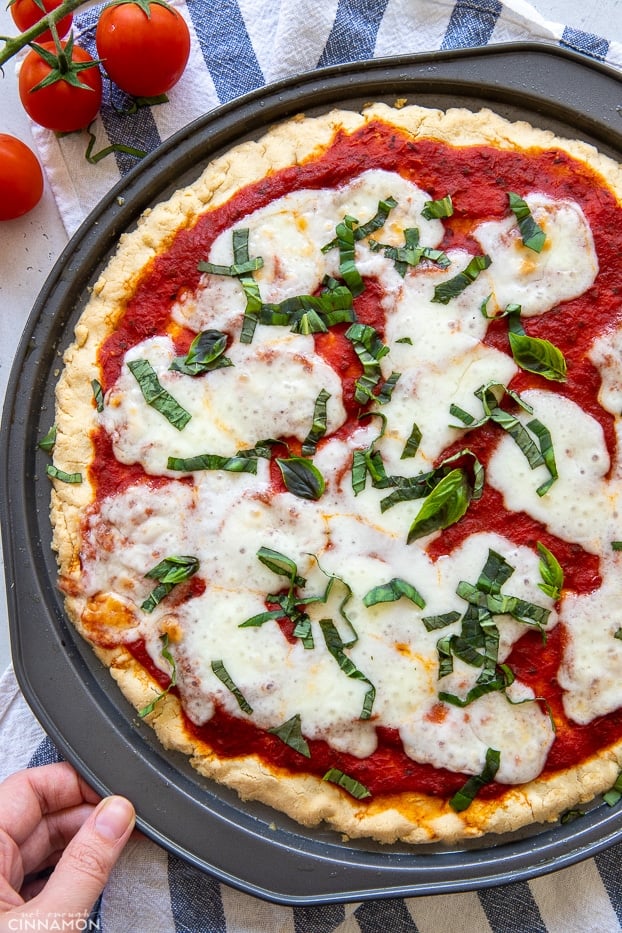 overhead shot of a gluten-free Paleo Pizza Margherita decorated with chopped basil 