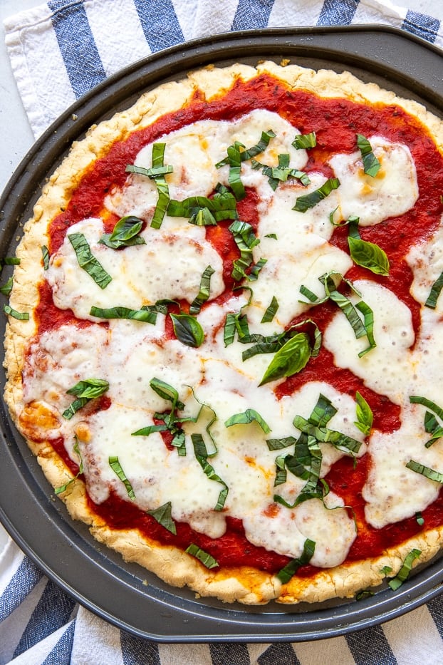 overhead shot of a healthy gluten-free Pizza Margherita made with paleo almond flour crust recipe